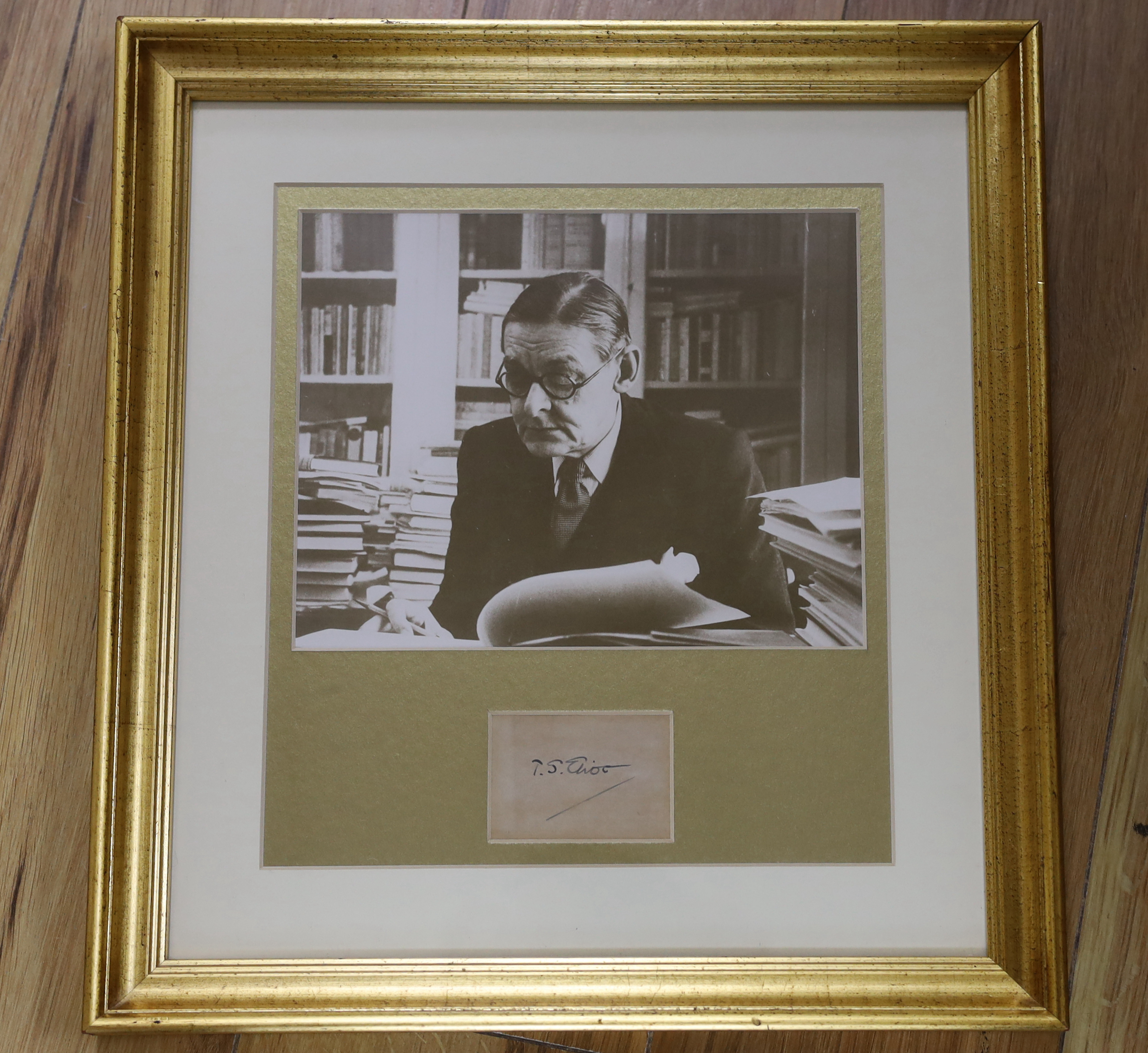 A framed photograph of T.S. Eliot with autograph